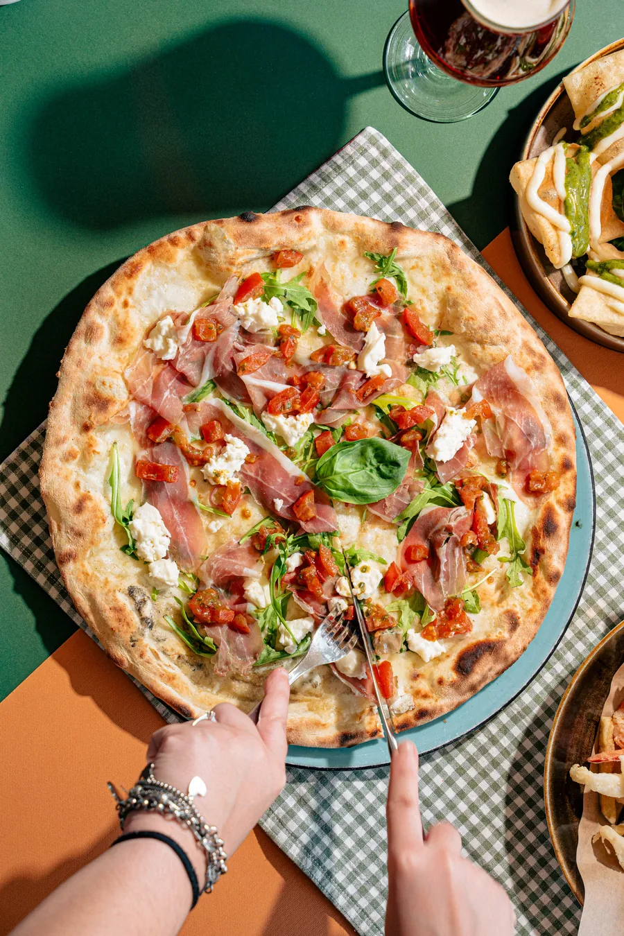 Amici al tavolo della Pizzeria Veneta che si dividono una pizza